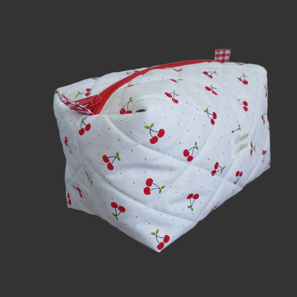Fabric bag with cherry pattern on a wooden surface