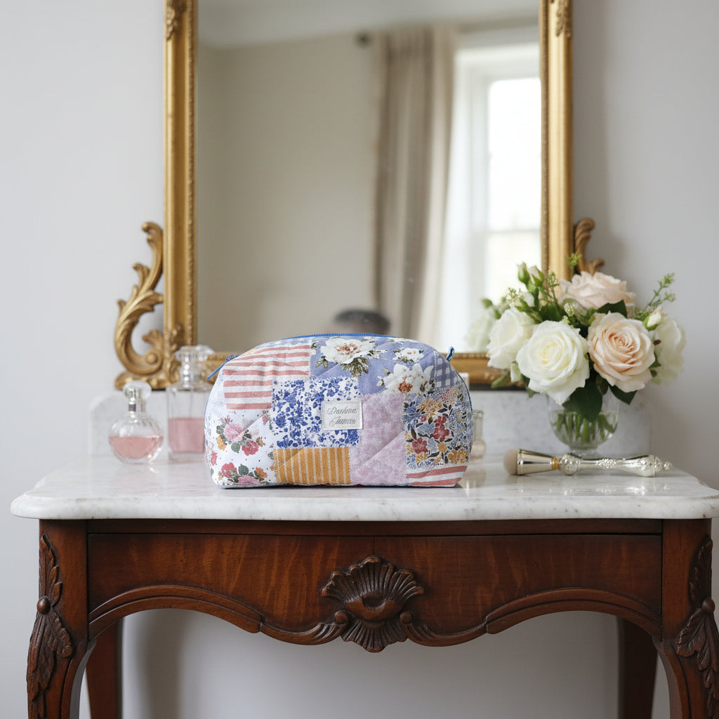 Floral patchwork quilt draped over a wooden chair against a white wall